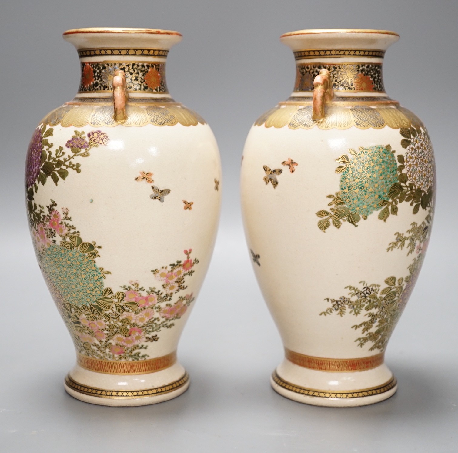 A pair of Japanese Satsuma pottery vases, 18.5cms high